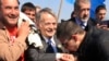 Crimean Tatars greet and escort Mustafa Dzhemilev (center) before attempting to pass a checkpoint connecting Ukraine's Kherson region and Crimea near the city of Armyansk on May 3.