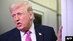 US President Donald Trump speaks to reporters aboard Air Force One on March 29, 2026.