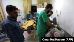 Wounded Syrians receive medical care in a hospital in Zardana, in the mostly rebel-held northern Syrian Idlib Province, following air strikes in the area on June 7.