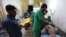 Wounded Syrians receive medical care in a hospital in Zardana, in the mostly rebel-held northern Syrian Idlib Province, following air strikes in the area on June 7.