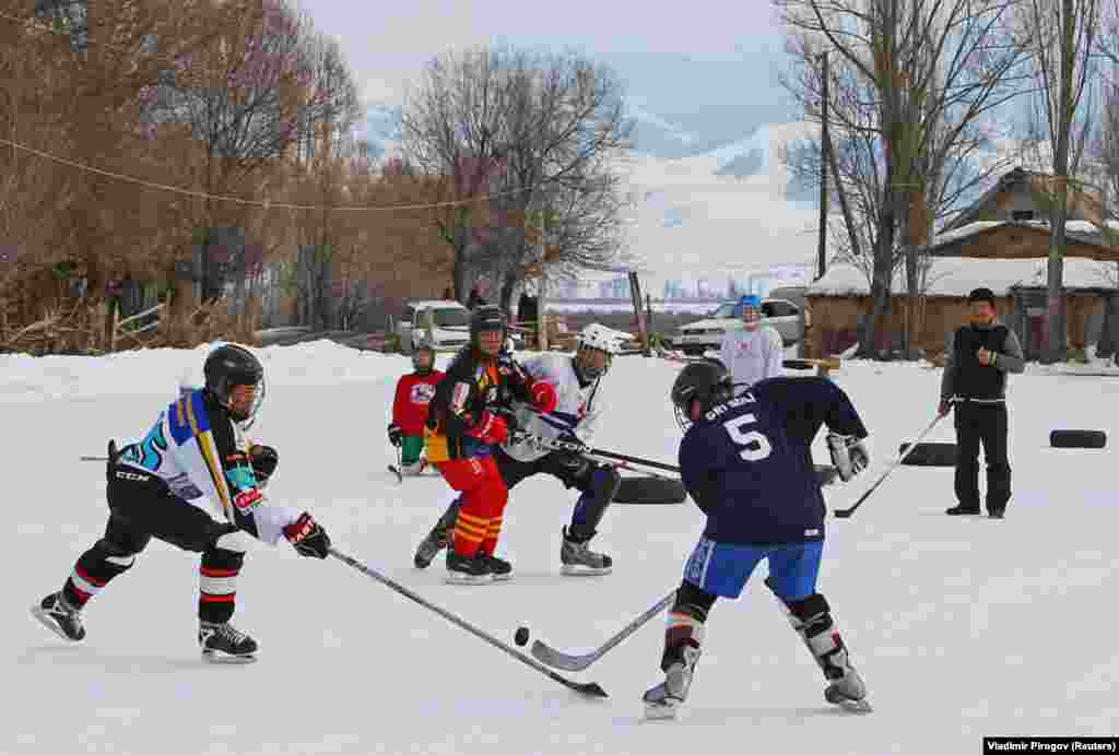 KYRGYZSTAN -- Young hockey players are seen in action during a training match between Kyrgyzstan's first female hockey team and the male team of the Karakol lyceum, in the village of Otradnoye, Kyrgyzstan February 4, 2020.