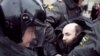 Russian Interior Ministry officers detain opposition activists in Moscow on March 31.