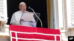 Pope Francis delivers the noon prayer on St. Peter's Square at the Vatican on August 25.