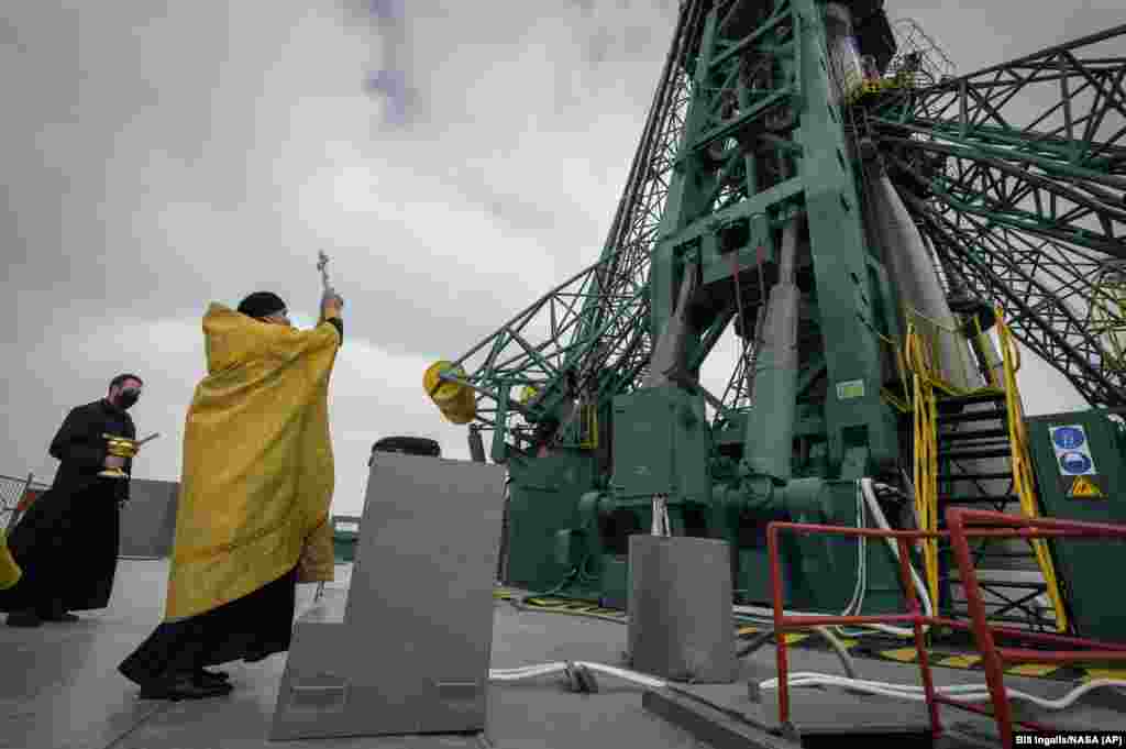 A Russian Orthodox priest blesses a Soyuz rocket at the Baikonur Cosmodrome&#39;s launch pad on April 8. (AP/Bill Ingalls)