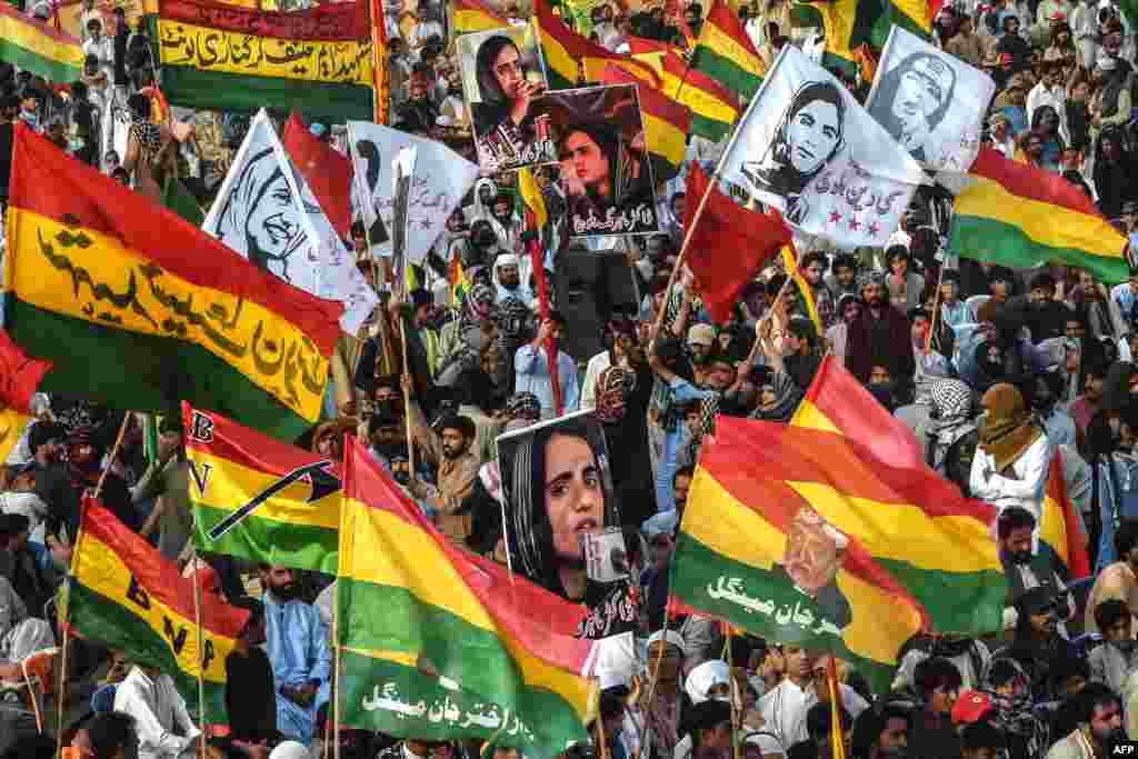 Supporters of the Balochistan National Party (BNP) carry posters of arrested Baloch activist Mahrang Baloch during a protest in Quetta, Pakistan.