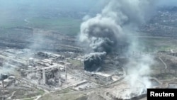 Smoke rises above the Azovstal steelworks in Mariupol in this still image obtained from a recent drone video posted on social media. Ukrainian Foreign Minister Dmytro Kuleba said the port city of Mariupol effectively doesn’t exist anymore because of the massive destruction by relentless bombardment.