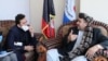 Hakeem Alakozai (R) talks with a an Afghan health ministry official in Kabul on May 30.