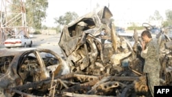The wreckage of vehicles at the site of a bomb attack in Falluja on October 7.