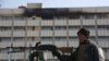 An Afghan police officer stands guard in front of the Intercontinental Hotel in Kabul on January 23.