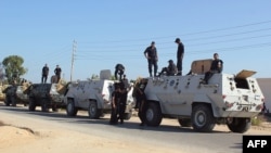 Egyptian security forces stand by their armored personnel carriers ahead of a military operation in the northern Sinai Peninsula on August 8.