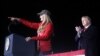 Republican Senator Kelly Loeffler addresses the crowd next to U.S. President Donald Trump at a campaign rally in Dalton, Georgia, U.S., on the eve of the run-off election to decide both of Georgia's Senate seats January 4, 2021.