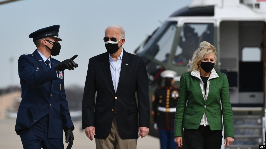 U.S. President Joe Biden, seen with First Lady Jill Biden, says the U.S. air strike in Syria was a warning that "you can't act with impunity."