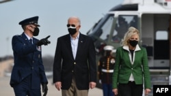 U.S. President Joe Biden, seen with First Lady Jill Biden, says the U.S. air strike in Syria was a warning that "you can't act with impunity."
