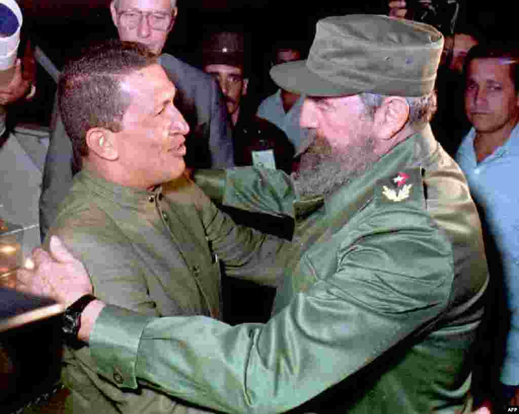 Cuban President Fidel Castro(R) greets retired Venezuelan military officer Hugo Chavez(L) upon his arrival at Jose Marti Airport in Havana 13 December. Chavez, who is the director of the political organization &quot;Bolivar Revolution 200,&quot; was one of the leaders of the bloody 1992 military coup to overthrow President Carlos Andres Per