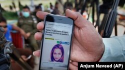 A local journalist shows a story published by an Italian news site regarding Sana Cheema, an Italian woman of Pakistani origin, in the neighborhood of Mangowal, near Gujrat.