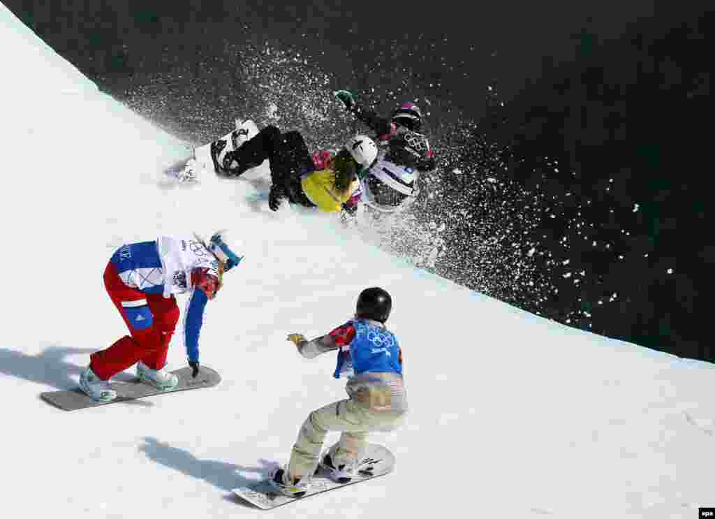 Michela Moioli of Italy (in black) collides with Alexandra Jekova of Bulgaria (in yellow) in front of Chloe Trespeuch of France (white) and Faye Gulini of the United States (blue) during the women&#39;s snowboard cross final at Rosa Khutor Extreme Park. (EPA/Sergei Ilnitsky)