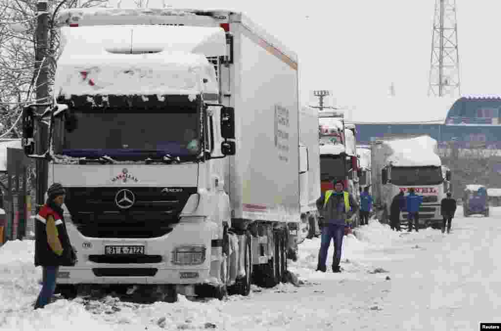 Romania - Trucks wait on a blocked road after heavy snowfall near Bucharest January 27, 2014.