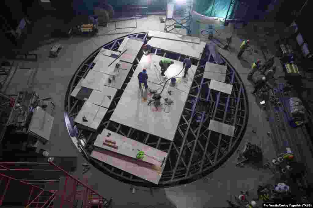 A rotating stage being built inside the theater in October 2025.“The point of this is to make sure that in people's memory this tragedy, in which civilians died, simply never took place,” Konstantin Batozsky, the founder of the Azov Development Agency said. “You don't see a bombed theater, therefore it never happened."