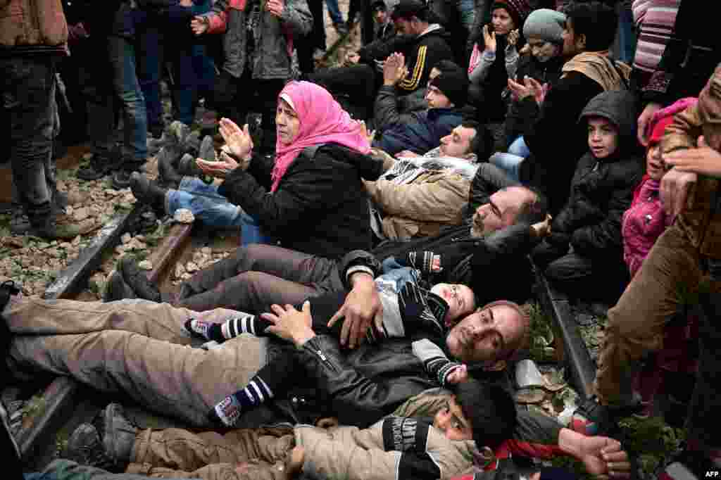 Syrian and Iraqi refugees trapped at the Greek-Macedonian border lie on railway tracks during a protest demanding the opening of the Idomeni crossing. Greece warned the number of refugees and migrants on its soil could more than triple next month, reaching as many as 70,000, as a Balkan cap on border crossings left thousands "trapped" in the country. (AFP/Louisa Goulimaki)