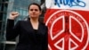 Belarusian opposition leader Svyatlana Tsikhanouskaya poses on October 6 in front of remains of the Berlin Wall at Potsdamer Platz that were repainted by Belarus activists during a rally to protest against police violence and to reject the results of the country's recent presidential election.