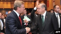 Turkey -- Turkish Prime Minister Recep Tayyip Erdogan(L) shakes hand with EU Commissioner Responsible for Enlargement Stefan Fule(R) before the opening sesion at the Ministry for EU Affairs Conference in Istanbul, 07Jun2013.