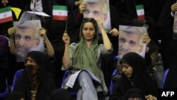 Supporters hold portraits of presidential candidate and lead nuclear negotiator Said Jalili during a campaign rally in Tehran on May 24.