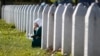 A woman mourns among graves at a Memorial Center near Srebenica for some 8,000 people who were killed in a massacre there during the Bosnian War. Srebrenica had been declared a safe zone by the United Nations at the time. 