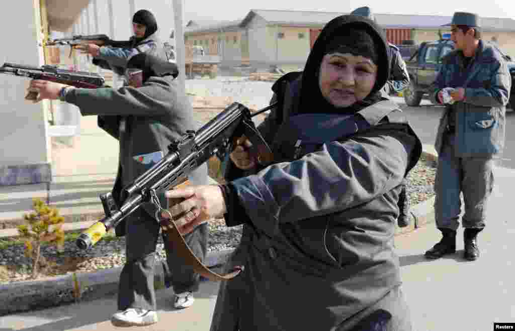 Female Afghan National Police (ANP) officers aim their weapons during a drill at a training center near the German Army Camp Marmal in Mazar-e Sharif. German police are mentoring the training program for the&nbsp; ANP as part of an ongoing International Security Assistance Force mission. (Reuters/Fabrizio Bensch)