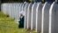 A woman mourns among graves at a Memorial Center near Srebenica for some 8,000 people who were killed in a massacre there during the Bosnian War. Srebrenica had been declared a safe zone by the United Nations at the time. 