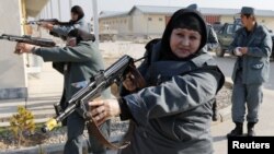 Afghanistan -- Female Afghan National Police (ANP) officers aim their weapons during a drill at a training centre near the German Bundeswehr army camp Marmal in Mazar-e Sharif, 11Dec2012