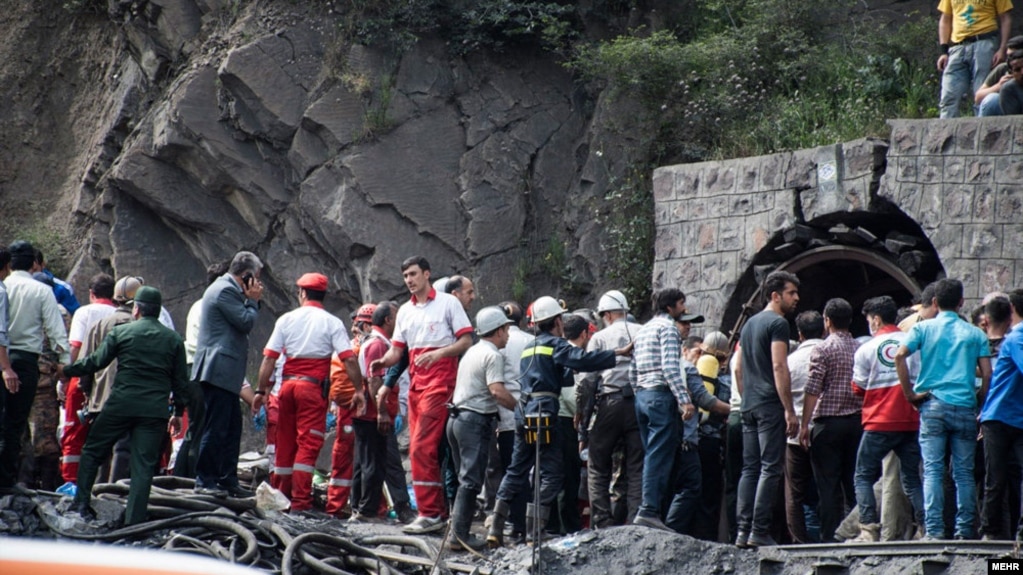 Coal miners and rescue workers gather at the scene of an explosion at a mine in Golestan Province that killed at least 35 people. 