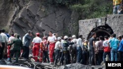 Coal miners and rescue workers gather at the scene of an explosion at a mine in Golestan Province that killed at least 35 people.