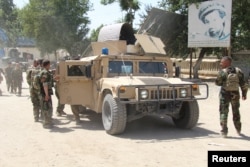 Afghan forces at the site of a clash with the Taliban in Kunduz Province on June 22.
