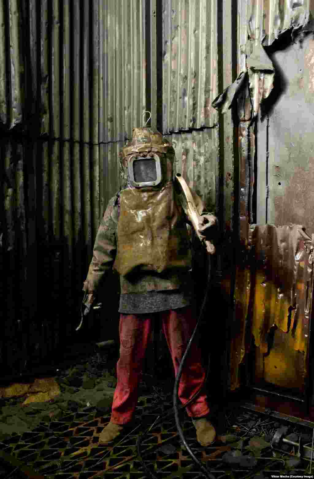 Portrait of a &quot;grinder&quot; in protective equipment in a foundry in Blansko in the Czech Republic. Grinders blast casts clean with sandy water.