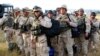 Georgian soldiers carry their gear upon arrival from Iraq at Tbilisi airport on August 11.