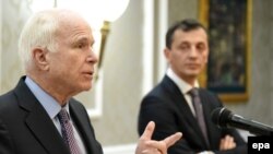 U.S. Senator John McCain (left) speaks during a joint press conference with Montenegrin Defense Minister Predrag Boskovic in Podgorica on April 12.