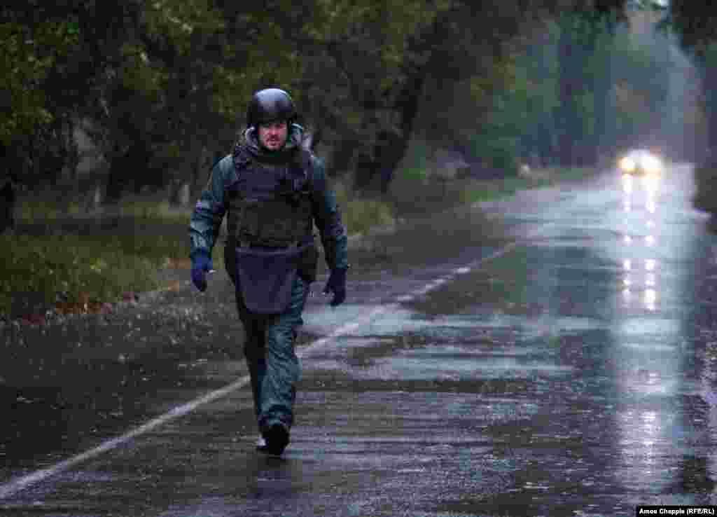 As rain and mortar shells fall, van Helten walks to the end of the road to check the painting.&nbsp;