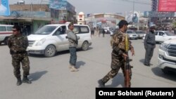 Afghan security forces keep watch near the site of a suicide bombing in Kabul on March 9.