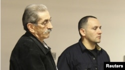 Dejan Radojkovic (left), a former Bosnian-Serb police commander wanted in his native country for alleged atrocities at Srebrenica, is seen in Las Vegas during his deportation on May 23.