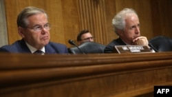 U.S. Senate Foreign Relations Committee Chairman Robert Menendez (left) and ranking member Bob Corker listen during a hearing before the committee on Capitol Hill in Washington last month.