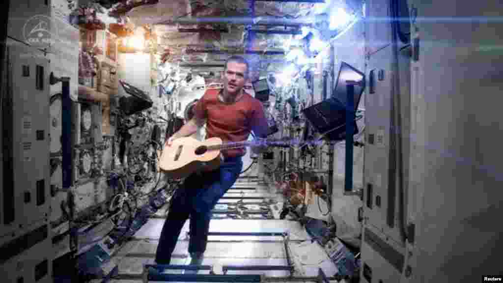 Canadian astronaut and International Space Station (ISS) Commander Chris Hadfield performs his zero-gravity version of David Bowie's hit "Space Oddity." The video, with its familiar refrain of "Ground control to Major Tom," has had millions of hits on YouTube and is being touted as the first music video ever filmed in space. Hadfield returned to Earth on May 14. (NASA via Reuters)