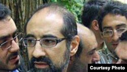 Iranian-American scholar Kian Tajbakhsh, seen here speaking to reporters in prison in September 2007, is among those currently on trial in Tehran.