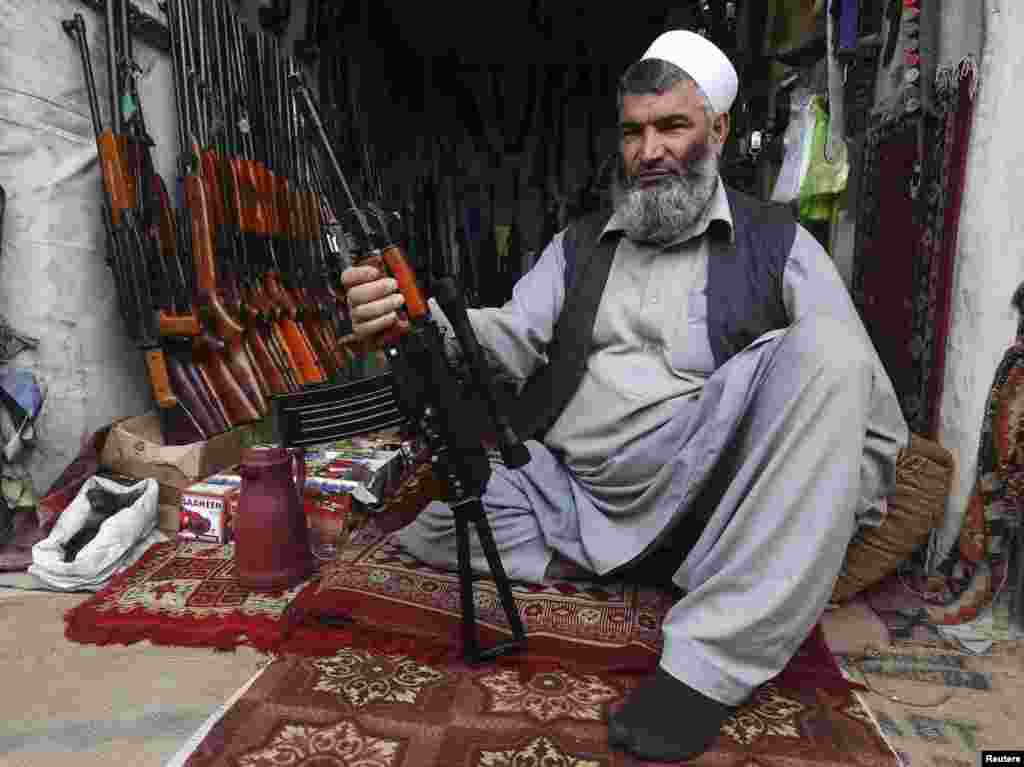 A man sells weapons on a street in the Afghan capital, Kabul. (Reuters/Omar Sobhani)