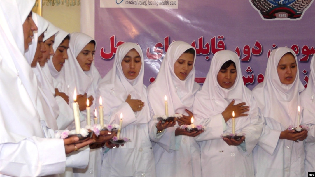 A group of Afghan girls who were trained as midwives take the oath of their profession in 2009.