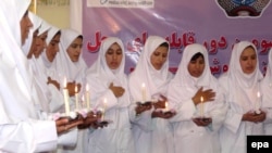 A group of Afghan girls who were trained as midwives take the oath of their profession in 2009.