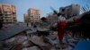 Rescue personnel conduct search and rescue work following a 7.3-magnitude earthquake at Sarpol-e Zahab in Iran's Kermanshah province on November 13, 2017. 