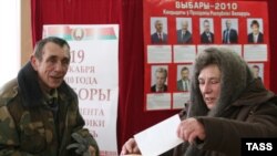 A woman casts her ballot during early voting in Minsk in mid-December.