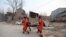 Rescue workers carry a victim after an earthquake in Dahejia, Jishishan County, in northwest China’s Gansu province on December 19, 2023.