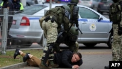 Police detain a man during an opposition march in Minsk in November 2020.