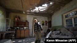 ARMENIA -- Aram Vardazaryan stands inside his home in the village of Aygepar recently damaged by shelling during armed clashes on the Armenian-Azerbaijani border, July 18, 2020.